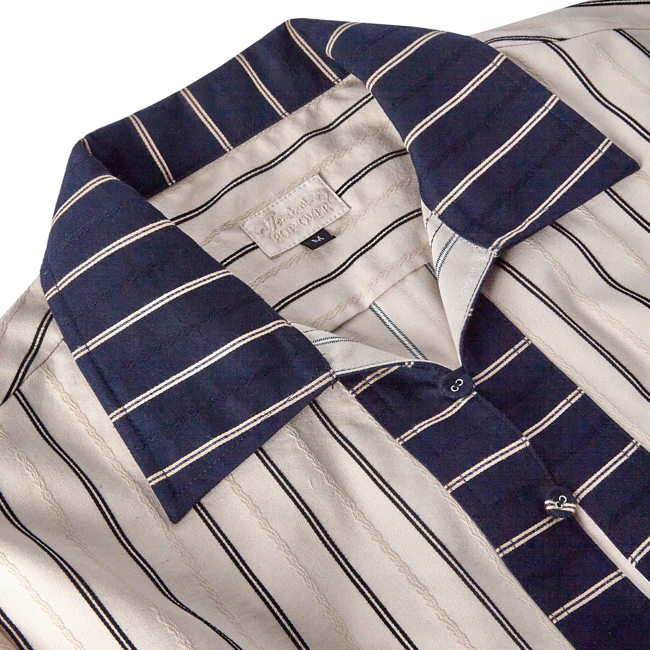 Close up of Tombolo pop-over navy striped collar and Special Tombolo pop-over tag in size medium 