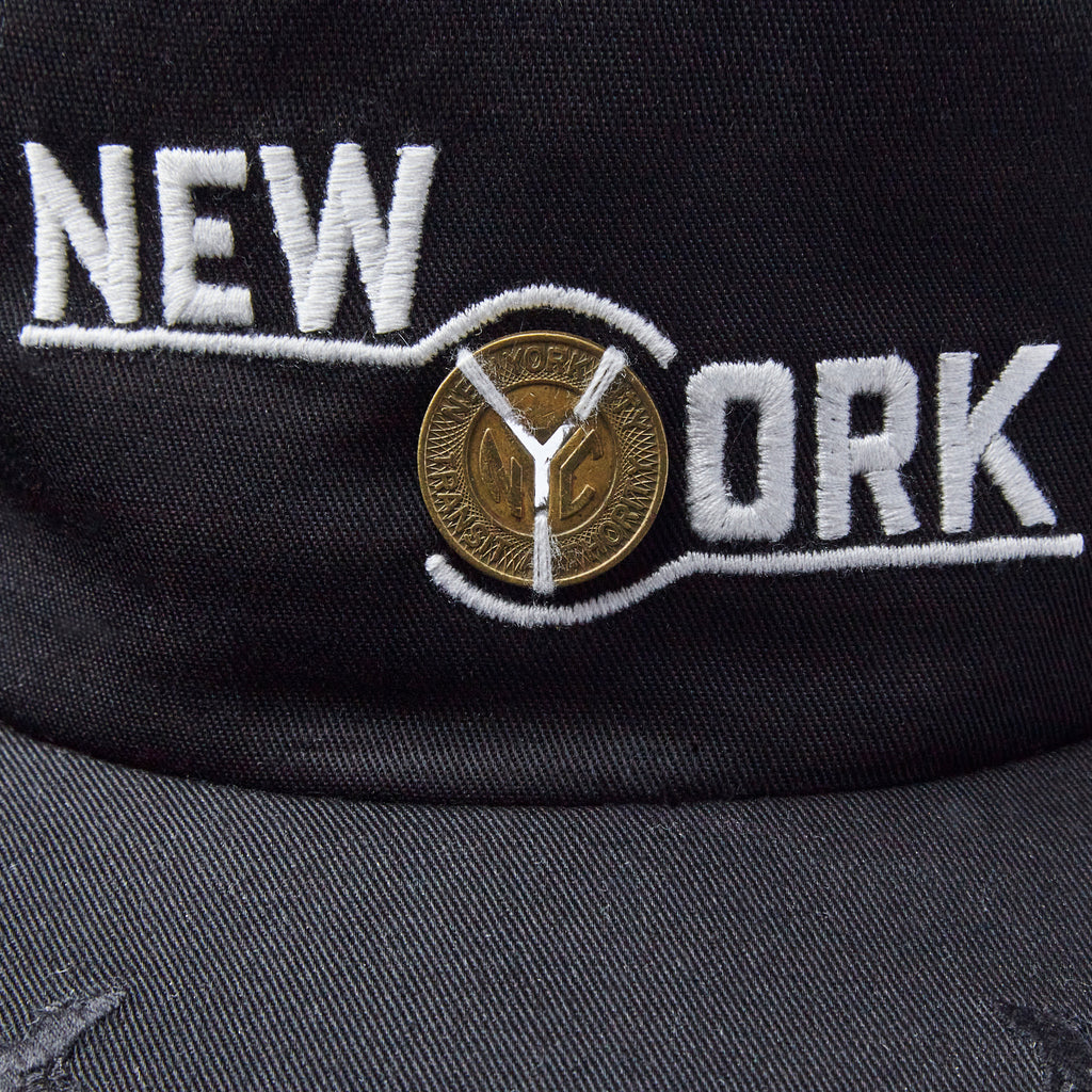 Close up of New York label embrodiery with light passing through the Y cutout of the token