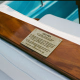 Brass plaque on wooden panel on 'Cea Pea' boat. 