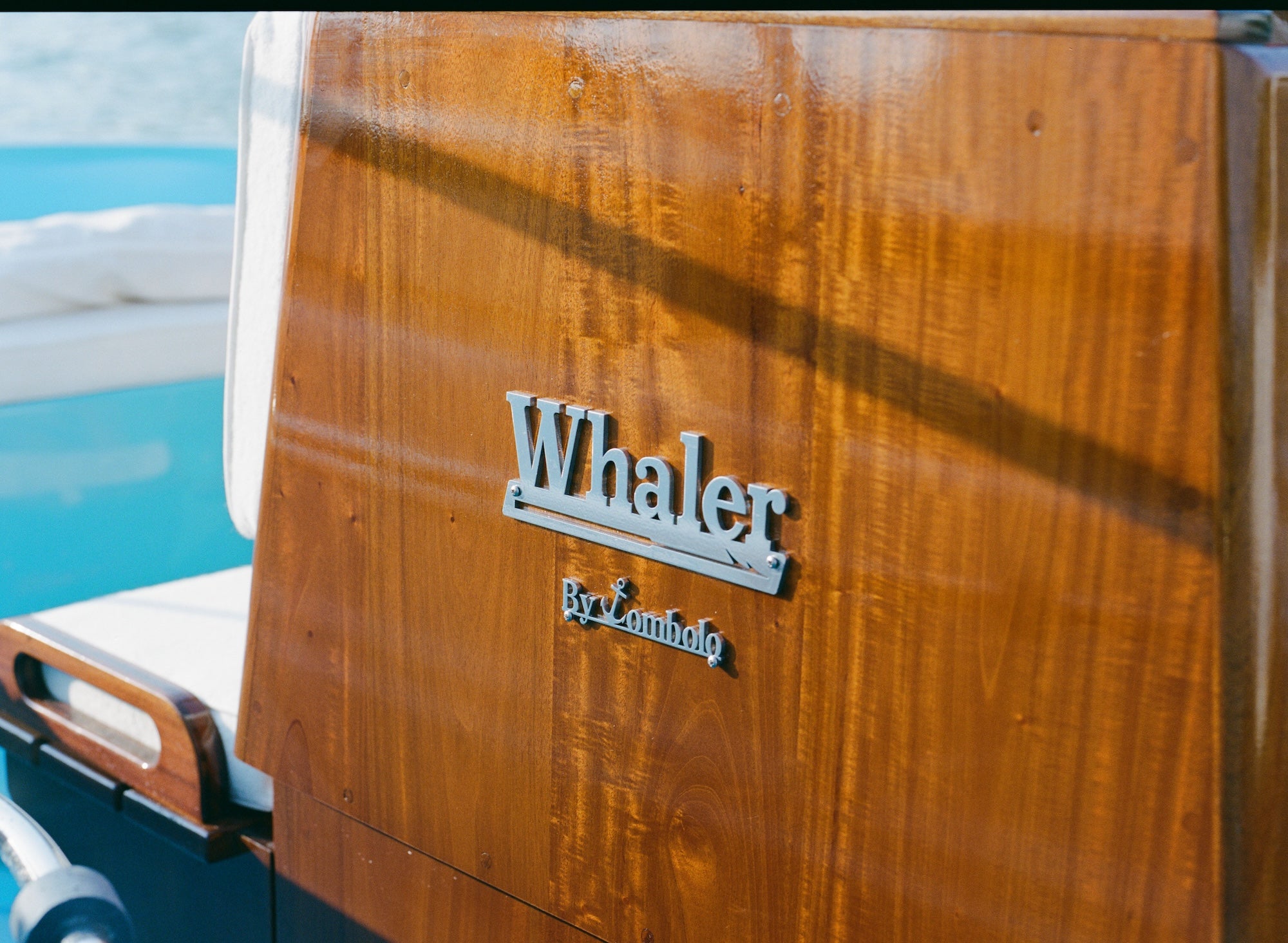 Close-up of 'Whaler by tombolo' logo featured on the boat. 