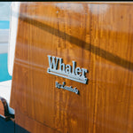 Close-up of 'Whaler by tombolo' logo featured on the boat. 