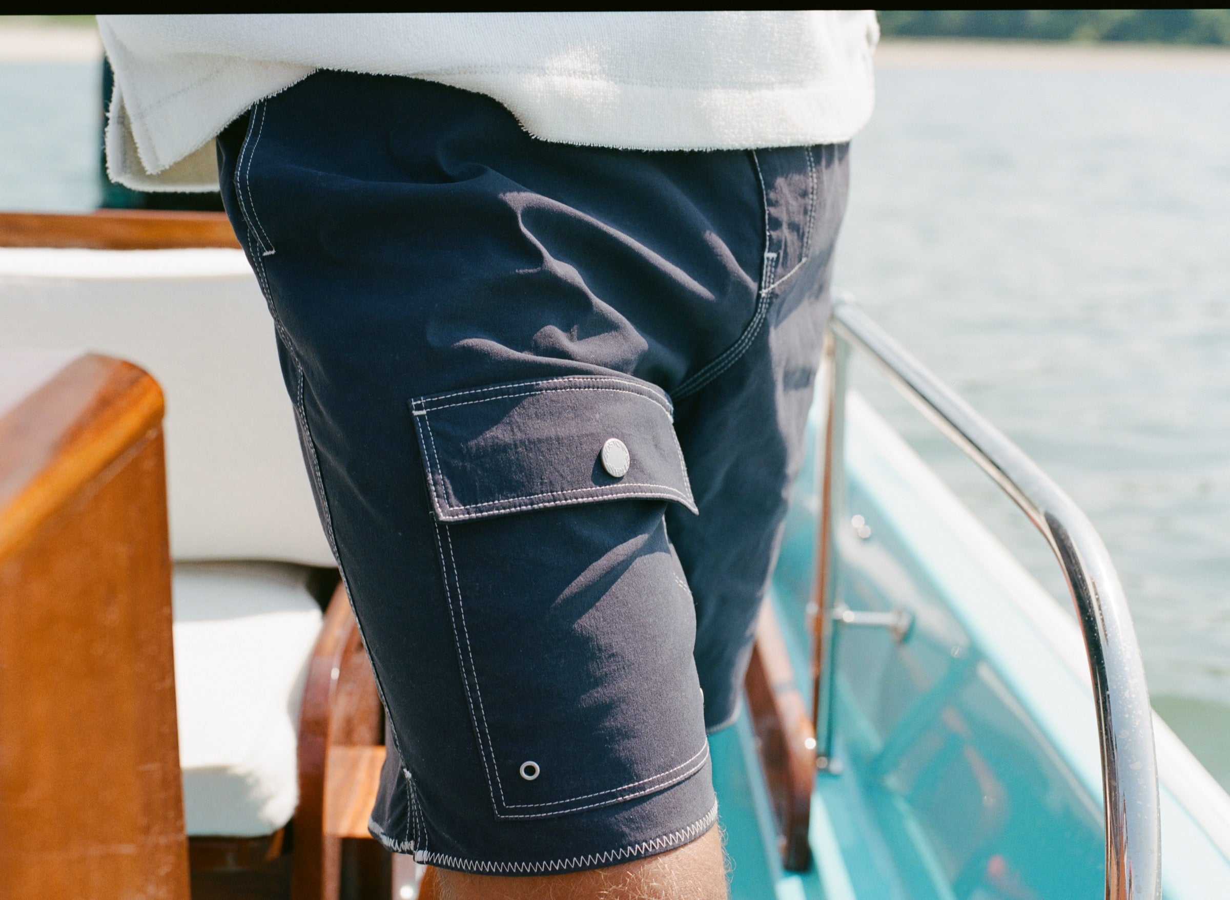 Close-up of the flap cargo pocket on the navy board shorts.