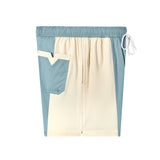 side view of oyster swim trunks with v pocket and beige blue color block
