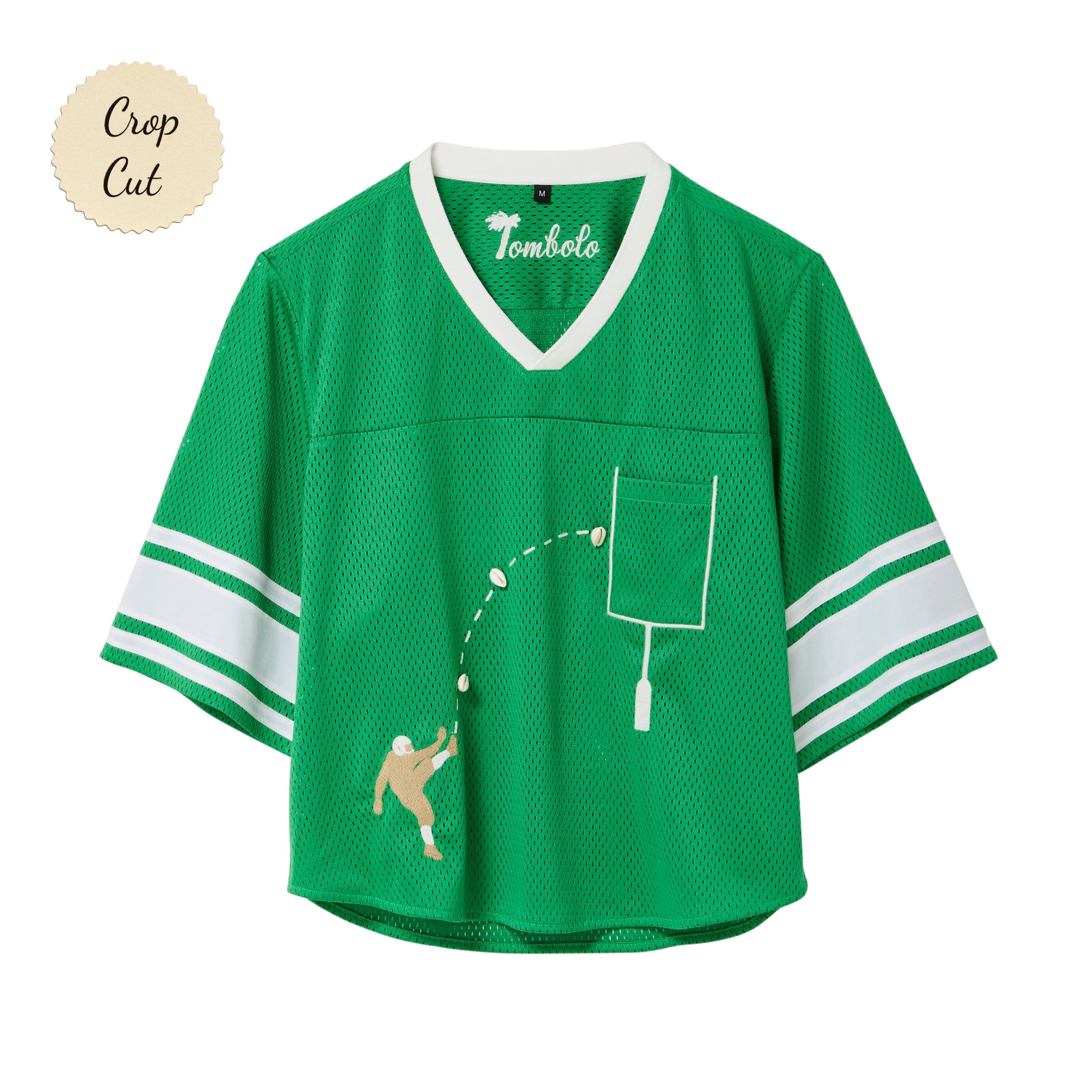 Green mesh crop-cut shirt with white stripes on the sleeves, a white V-neck, and an embroidered football design showing a player kicking a football toward a goalpost outlined around the chest pocket.