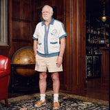 Older gentleman standing in the Explorer's Club entrance, wearing our 'Explorer's Club' Chum Cabana and our  'Explorers Club' 5-Panel Souvenir Cap.