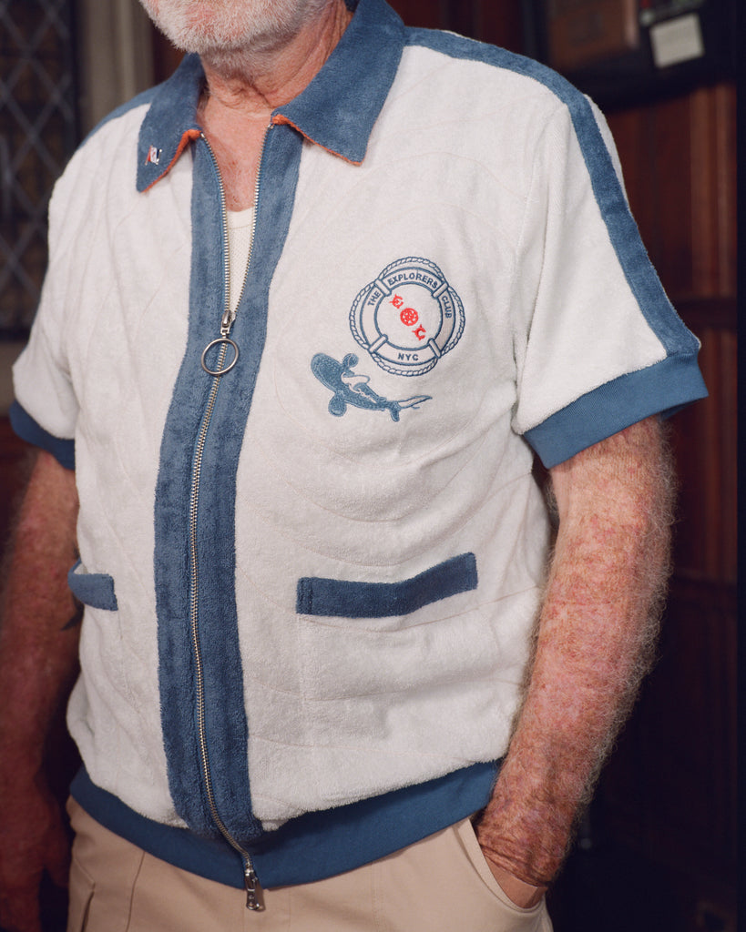 Close-up of older gentleman wearing the 'Explorer's Club' Chum Cabana mostly zipped. His hand is in his pocket. 