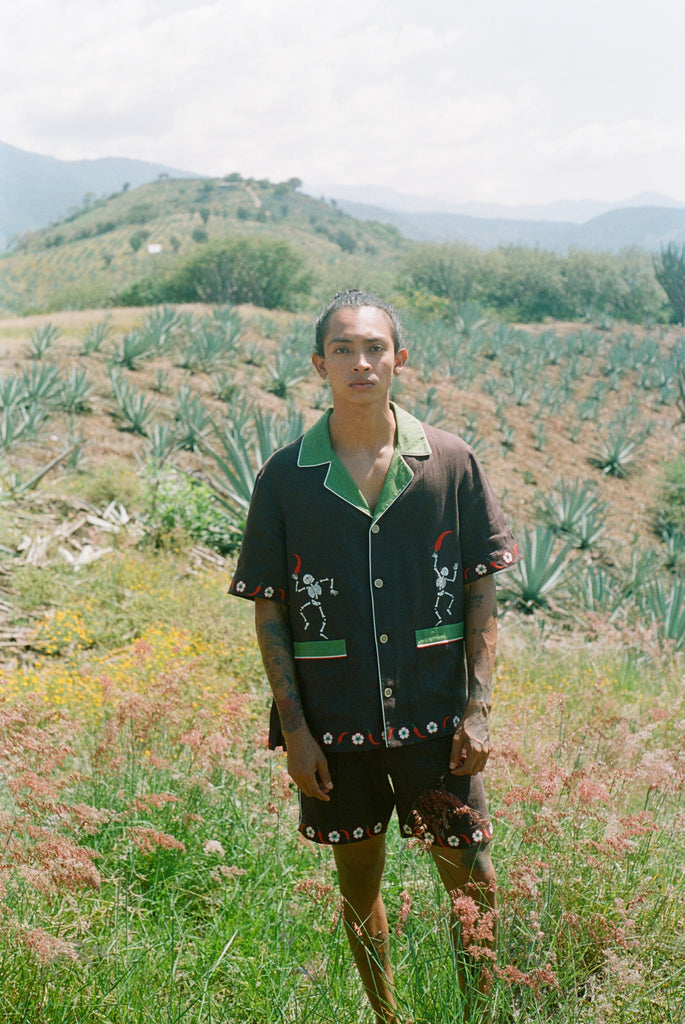 Man standing in field wearing full 'Picante' cabana set in linen.