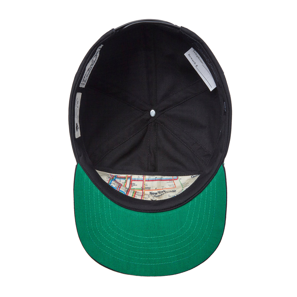 Underside of hat with green brim underneath 