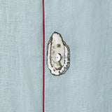 close up of embroidered oyster on top of middle shirt button