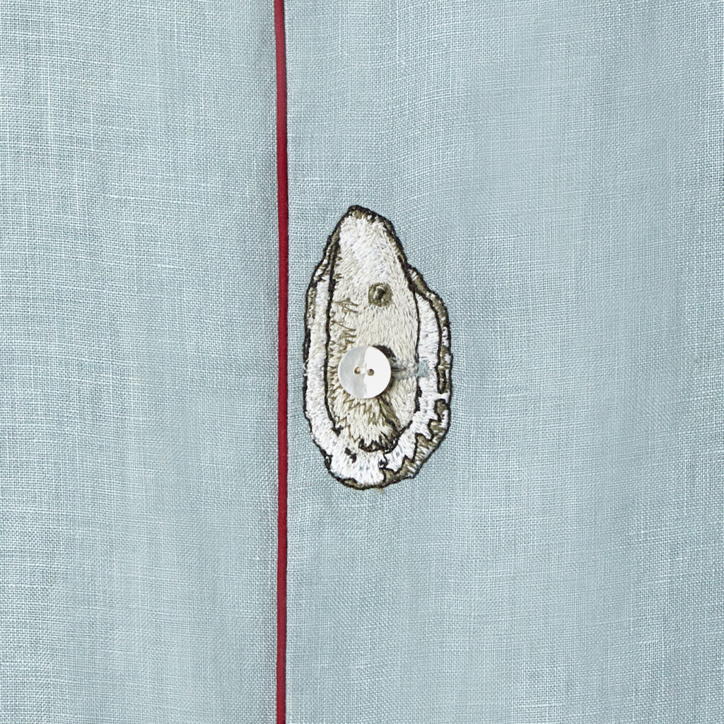 close up of embroidered oyster on top of middle shirt button