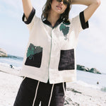 Female model wearing full 'Tombarola' cabana set on the beach.
