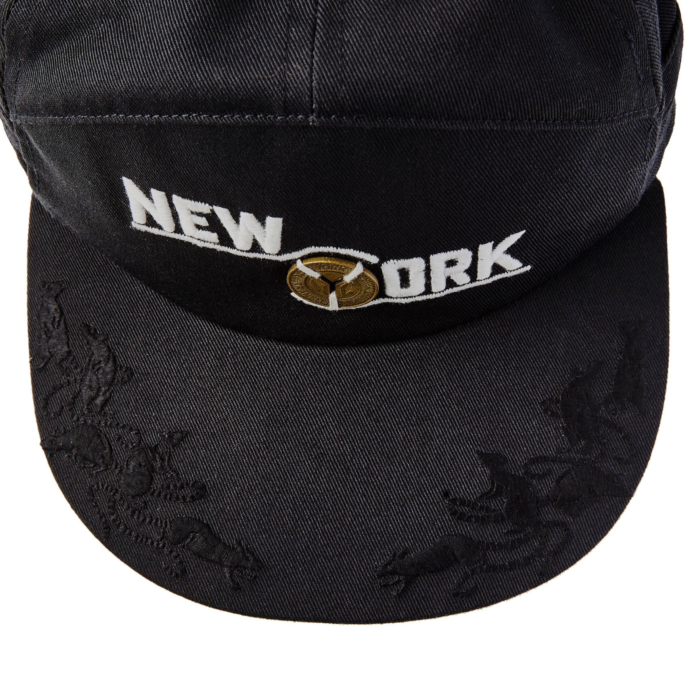 Birdseye view of New York cap showing embroidered animal motifs 