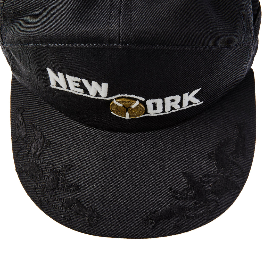 Birdseye view of New York cap showing embroidered animal motifs 