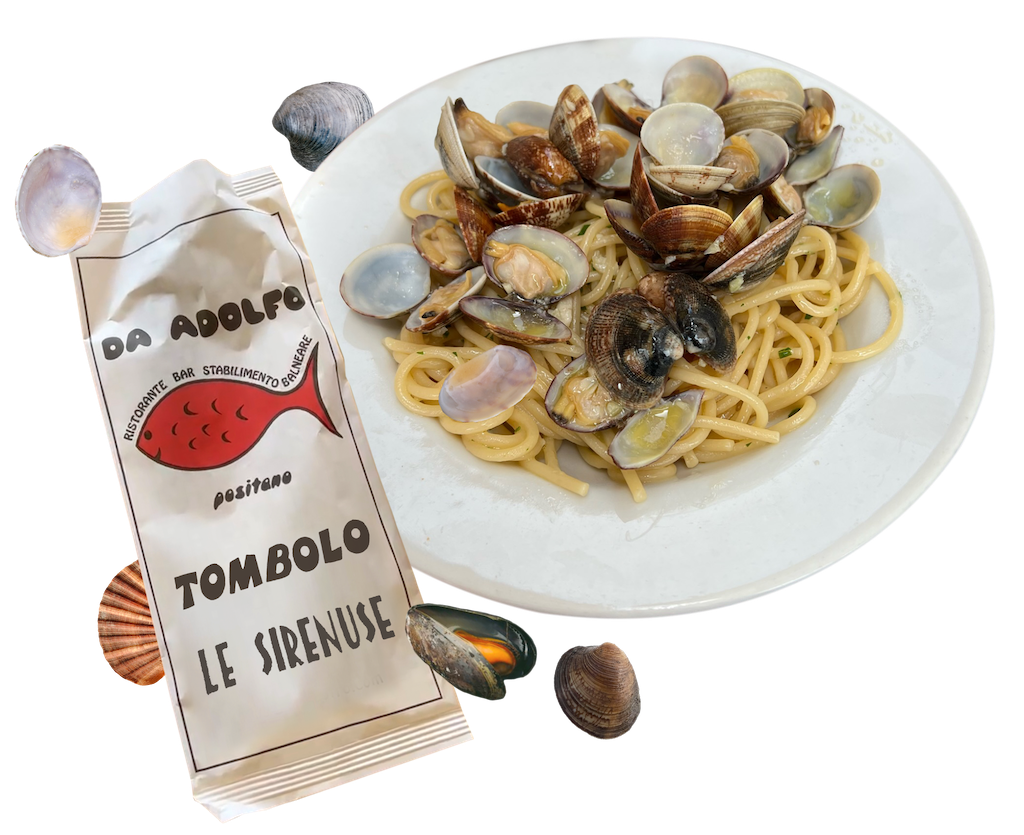 Tombolo Da Adolfo and Le Sirenuse names printed on cutlery bag next to a plate of spaghetti alle vongole 