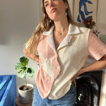 Aemelia looks off camera with hands on hips