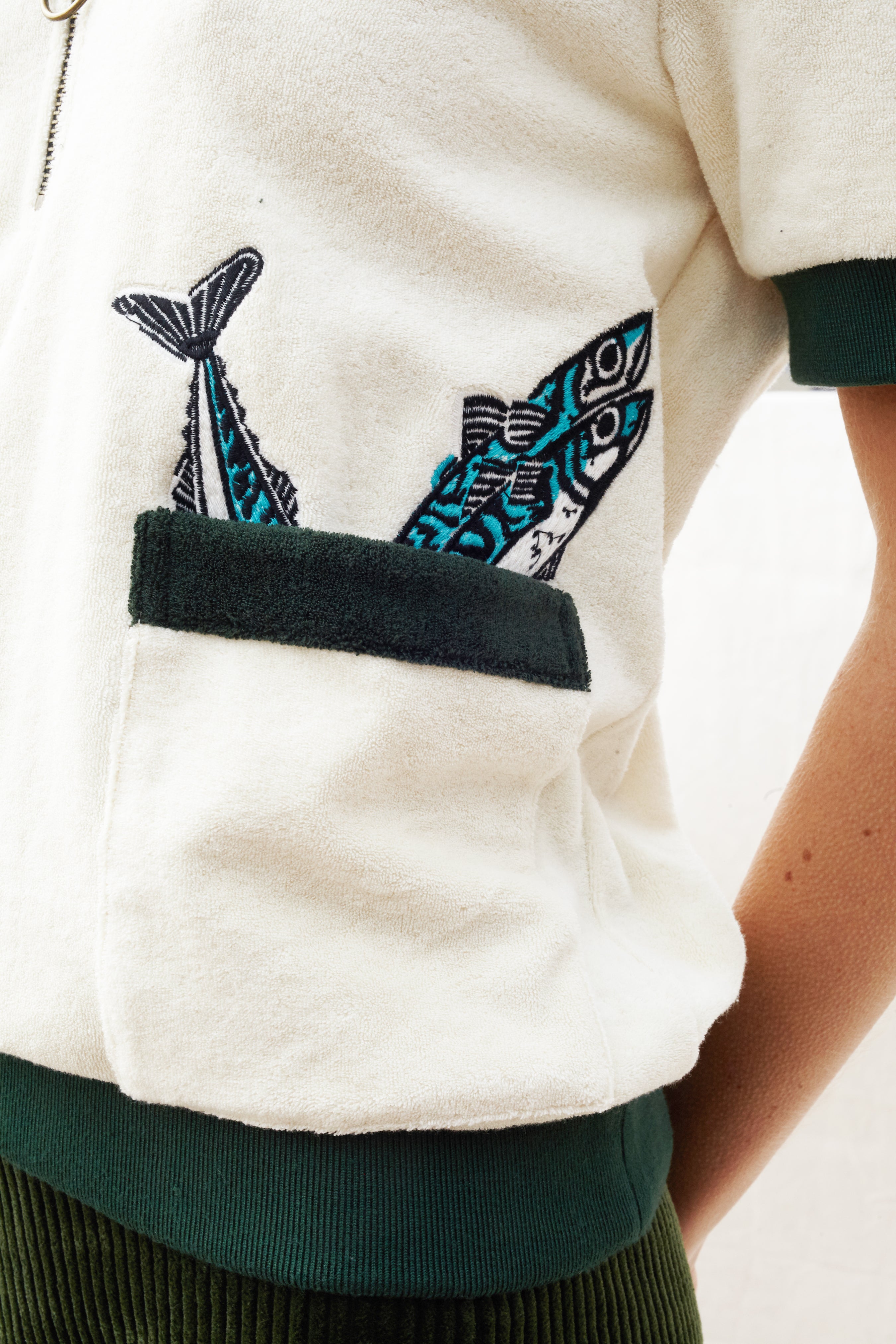 Close up of the right pocket lined with two embroidered fish