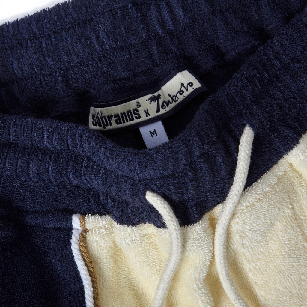 Close-up product image of 'The Sopranos' Bada Bing Cabana Shorts' custom interior tag that has both the "Sopranos' and "Tombolo" logo.