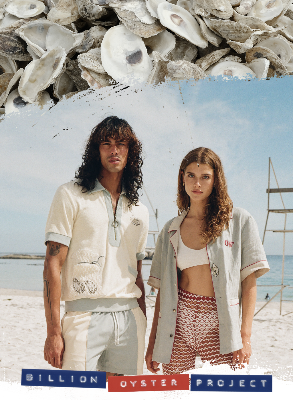 Man and woman gazing at the camera on the beach wearing Tombolo x Billion Oyster Project shirts in linen and terry cloth