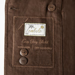 Close up image of the inside label with a Tombolo logo and two spare buttons.