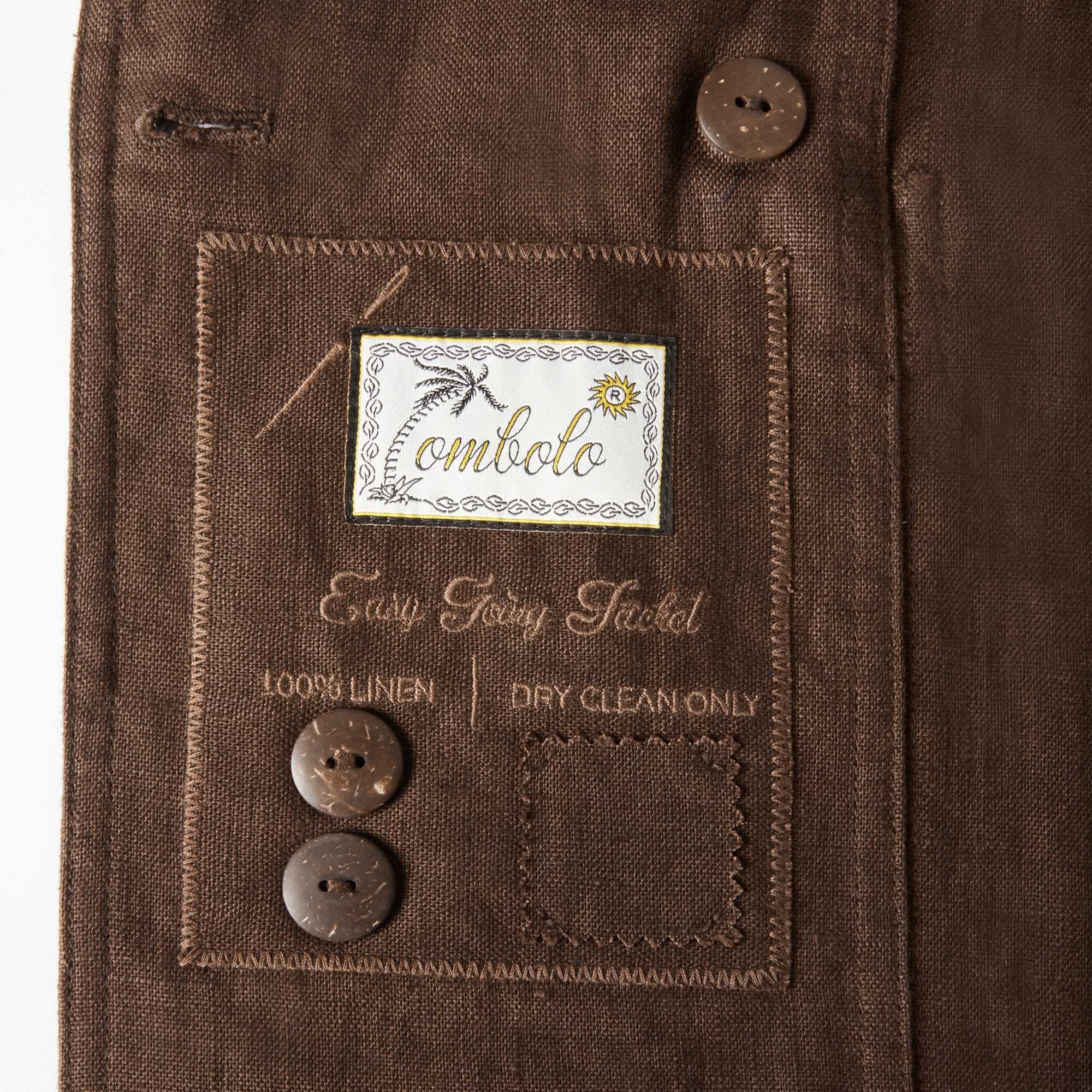 Close up image of the inside label with a Tombolo logo and two spare buttons.