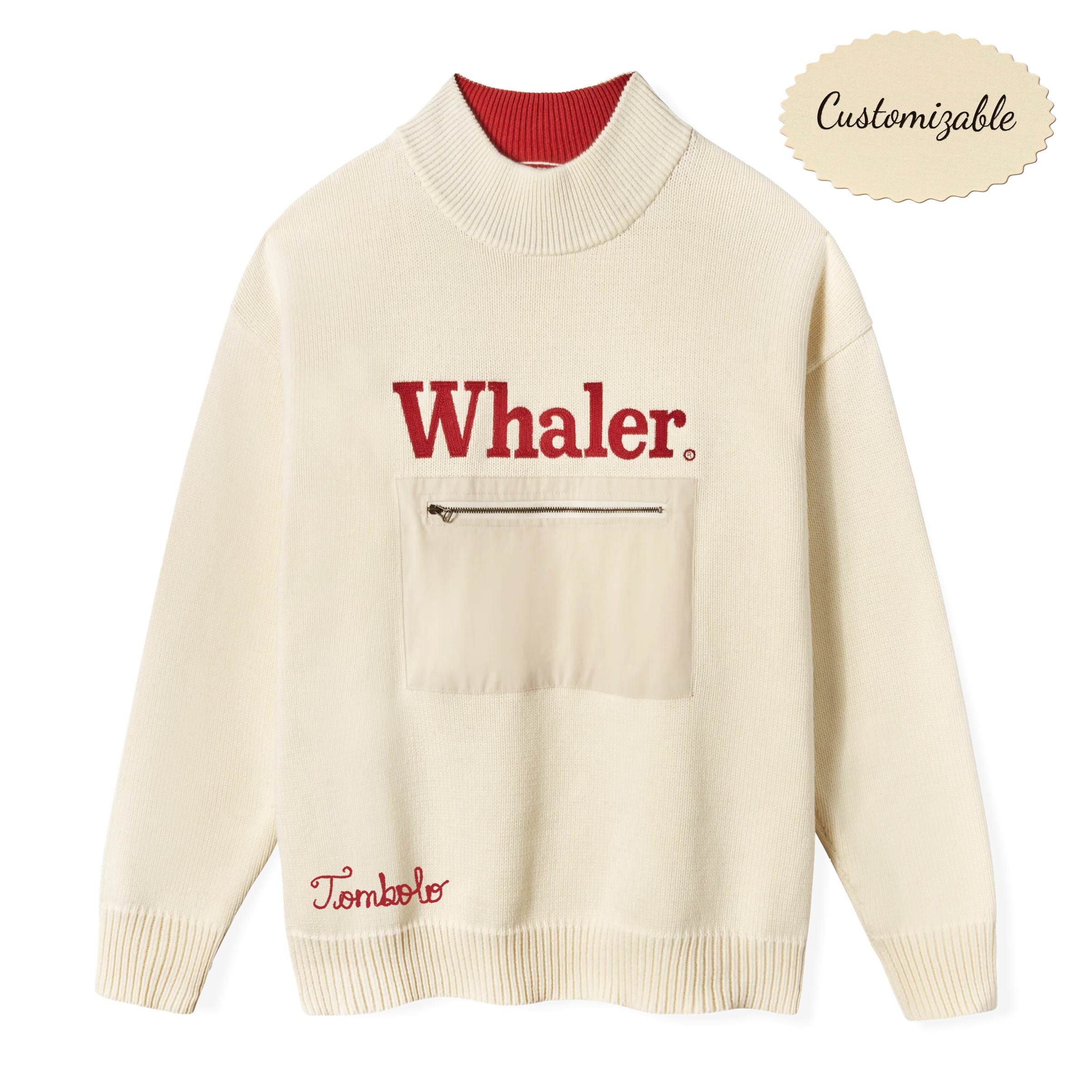 Cream knit sweater with red interior collar. Features bold red embroidered text reading 'Whaler' across the chest and a beige front zip pocket. 'Tombolo' embroidered in red near the waist. 