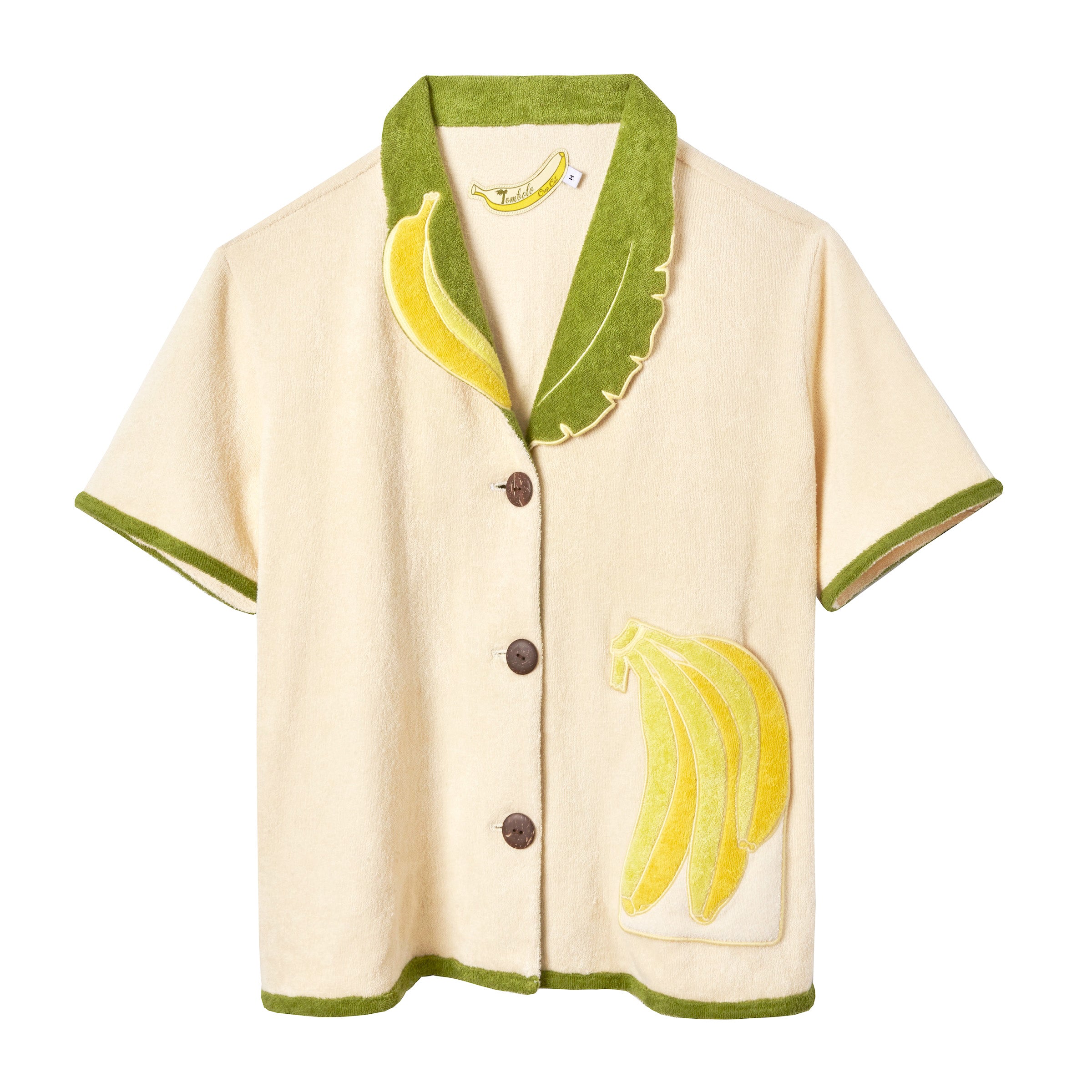 Short-sleeve cream terry cloth shirt with green trim, a green and yellow banana leaf collar, and a banana applique on the front pocket.
