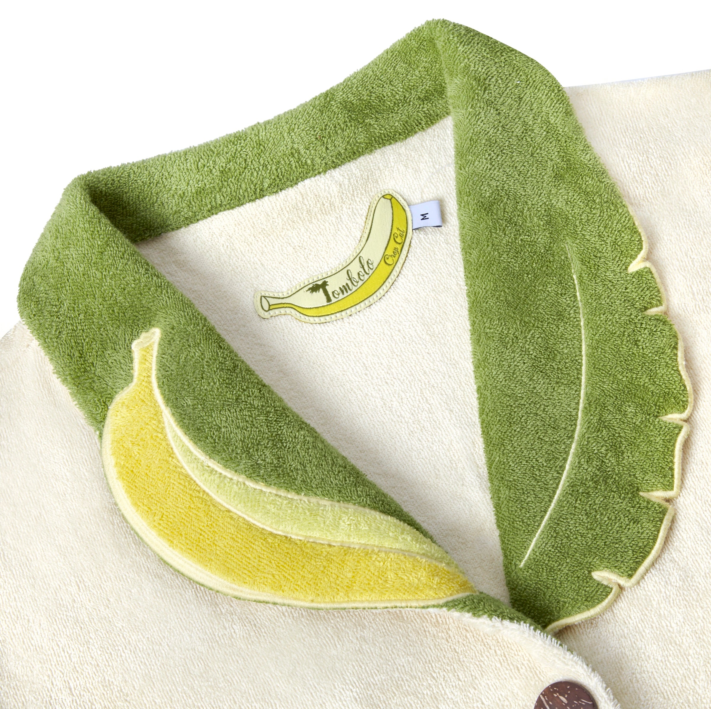 Close-up of the interior label, in the shape of a banana, reading 'Tombolo Crop Cut'.