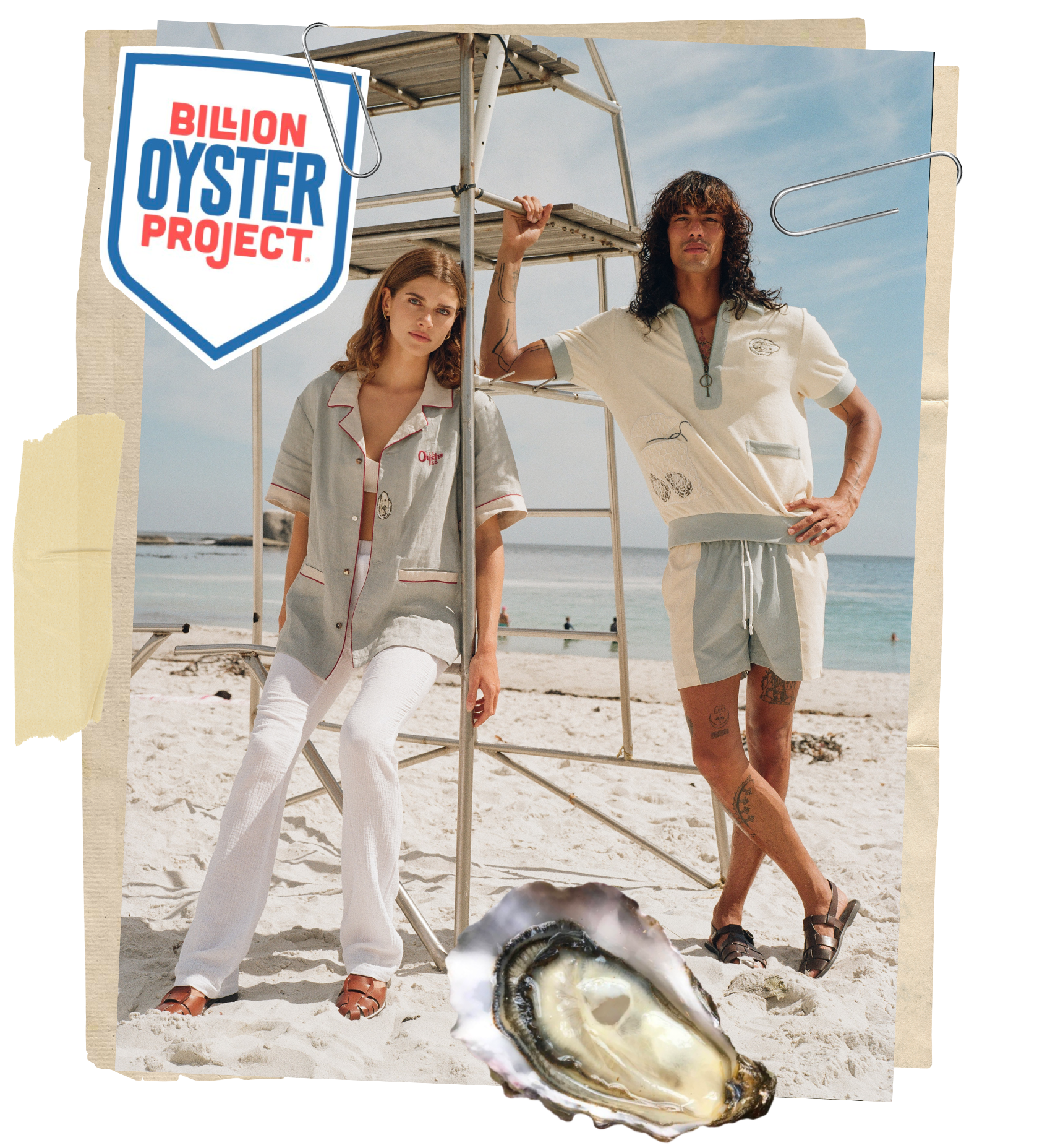 woman and man leaning against lifeguard chair in Tombolo oyster themed shirts with ocean in the background