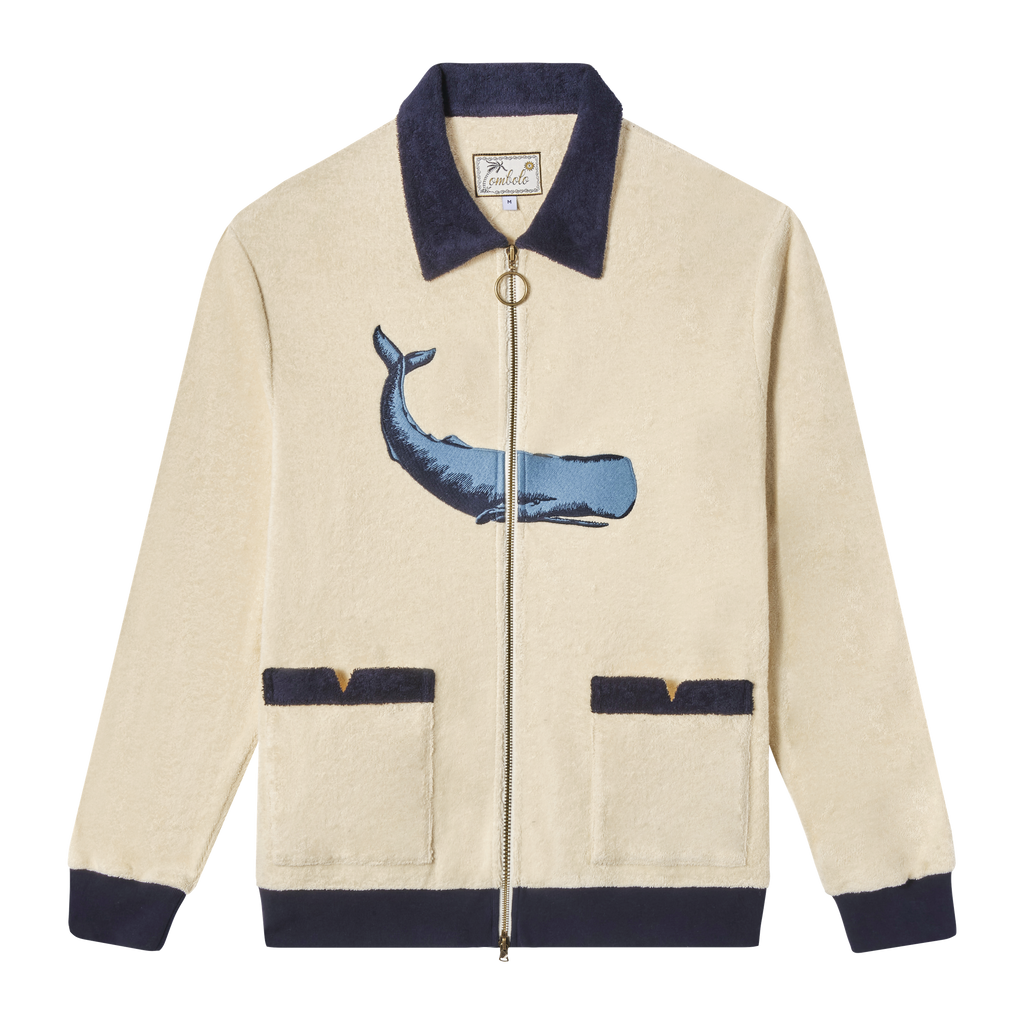 Full-zip long sleeve cabana shirt in beige with a contrast navy collar and cuffs featuring an embroidered whale on the front. 