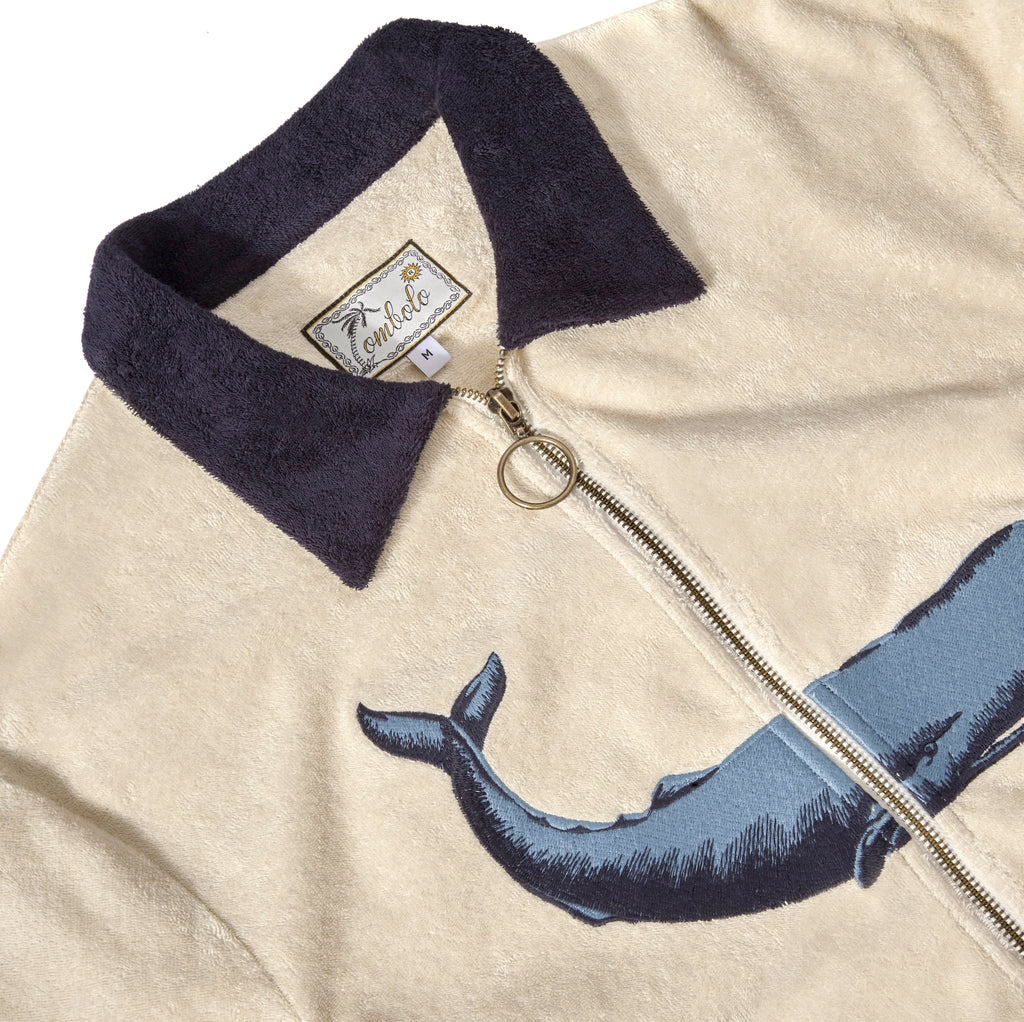 Close-up of the zipper feature, dark blue collar, and interior label reading 'Tombolo.'