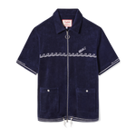 Front-facing product image of the 'Boston Whaler' Cabana (Navy) that features a chainstitched harpoon hull stripe on cuffs and bottom sweep, embroidered 'Boston Whaler' surfing a following sea of chainstitched repeating waves, drawstrings with barrel stopper knots, two-way, nickel zipper with ring pull, custom 'Tombolo & Boston Whaler' woven interior label secured with zig-zag sail stitch, and front patch pockets with nickel snaps embossed with 'Boston Whaler.'