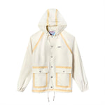 Front view of a cream hooded rain jacket with tan trim, silver snap buttons, and two large front pockets. Features the Boston Whaler logo on the left chest.