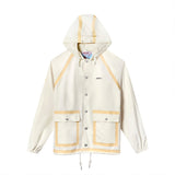 Front view of a cream hooded rain jacket with tan trim, silver snap buttons, and two large front pockets. Features the Boston Whaler logo on the left chest.