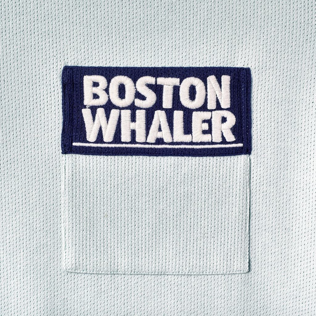 Close-up of color blocked chest pocket with embroidered 'Boston Whaler' logo.