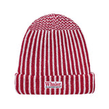 Red and white striped knit beanie with a folded brim. Features a 'Whaler The Unsinkable Legend' patch on the front.