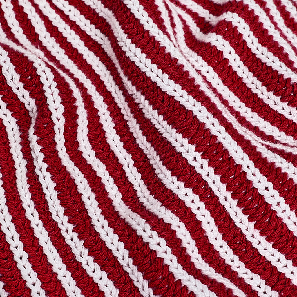 Close-up of the red and white striped knit material.
