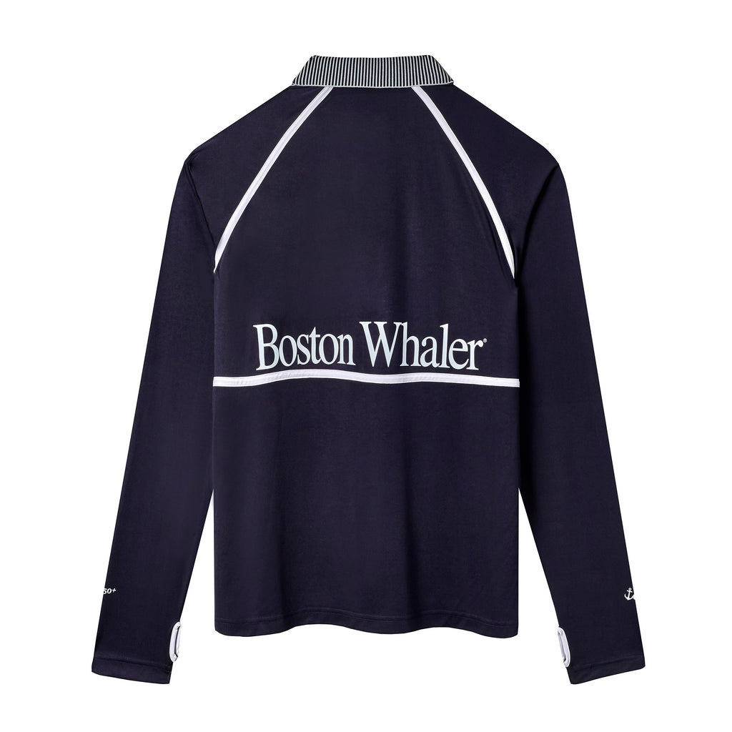 Back view of a navy long-sleeve sun shirt with white piping and a striped collar. Large white text across the upper back reads 'Boston Whaler.'