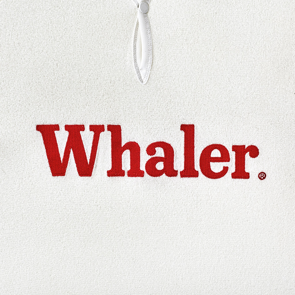Close-up of the red 'Whaler' text across the chest. 