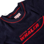 Close-up product image of the 'boston whaler souvenir terry tee that showcases the interior label tag, and Whaler logo on the front of the shirt.