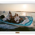Two people on a boat in the water with a scenic background