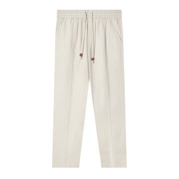 Front-facing product image of the 'Easy-Going Pants' in Sand linen that showcases its elasticized waist linked to drawstrings with varnished wood stoppers, sewn pleat, functional button-fly, and zippered side pocket concealed on right side seam, shot on a white background.