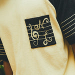 Close-up of SNL embroidery on chest pocket. 