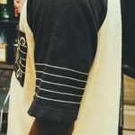 Close-up image of the side of the sleeves, featuring a musical staff. 