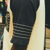Close-up image of the side of the sleeves, featuring a musical staff. 