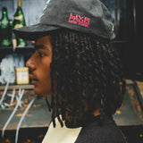 Man wearing a cap with 'Live from New York' text on the left temple.