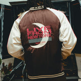 Back view of brown satin souvenir jacket with 'Live from New York' on back.