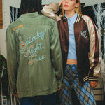 Two models wearing different 'SNL' products, one shown from the front and one from the back.