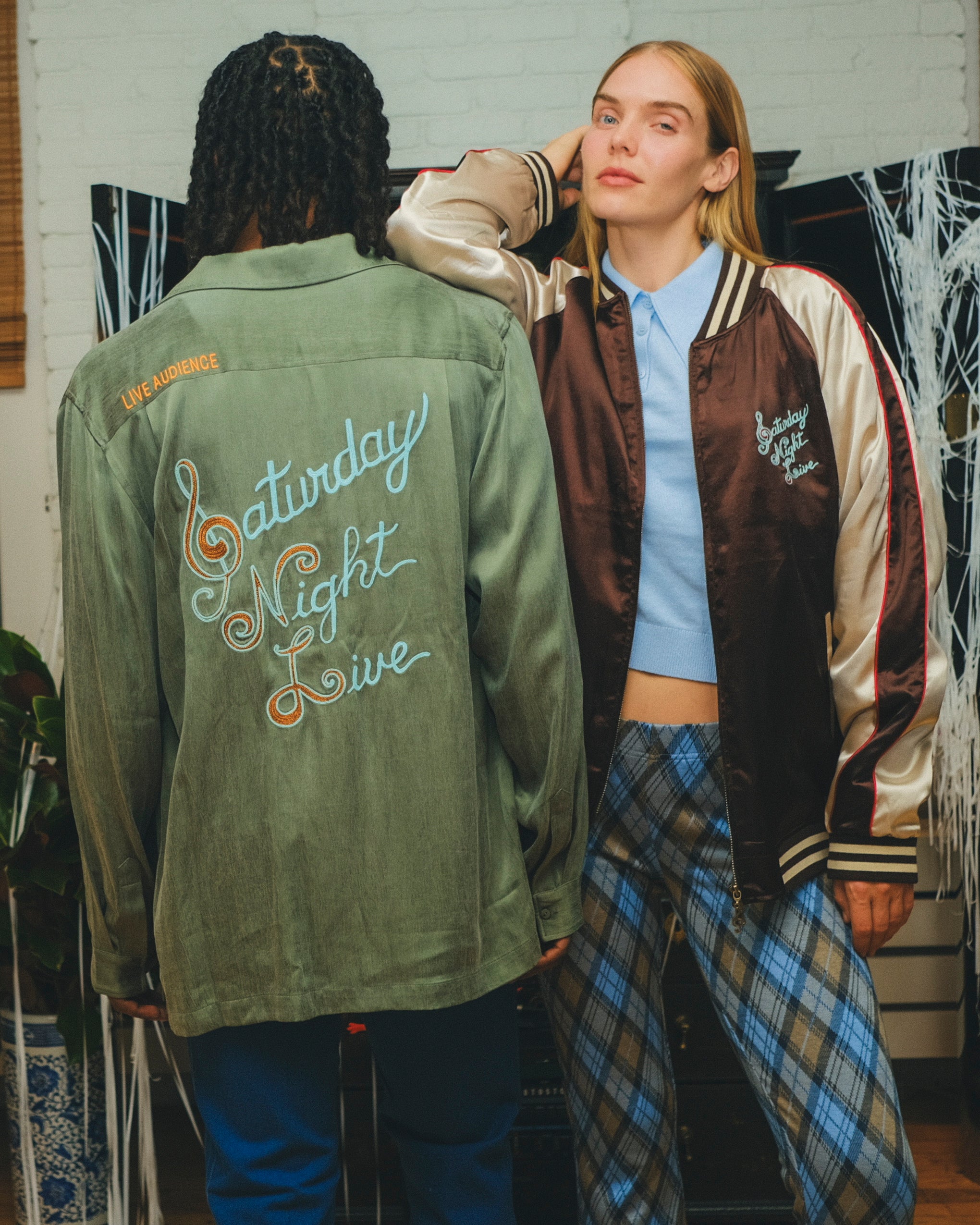 Two models wearing different 'SNL' products, one shown from the front and one from the back.