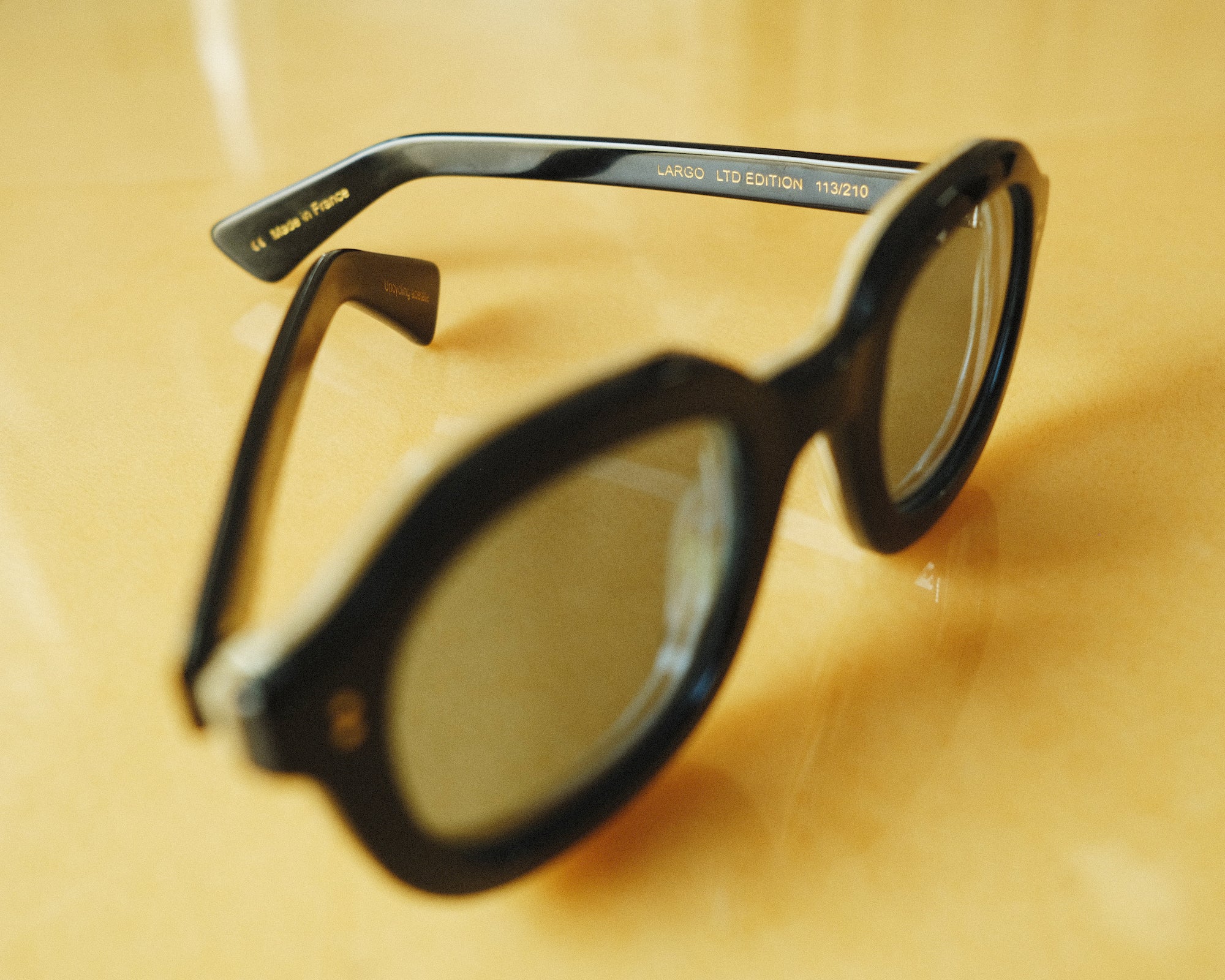 close up of black framed sunglasses with 'LARGO LIMITED EDITION 113/210' in interior