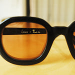 Lesca Lunetier X Tombolo lens in coral that showcases the ability to see the Lesca X Tombolo graphic on the frame through the coral lens.